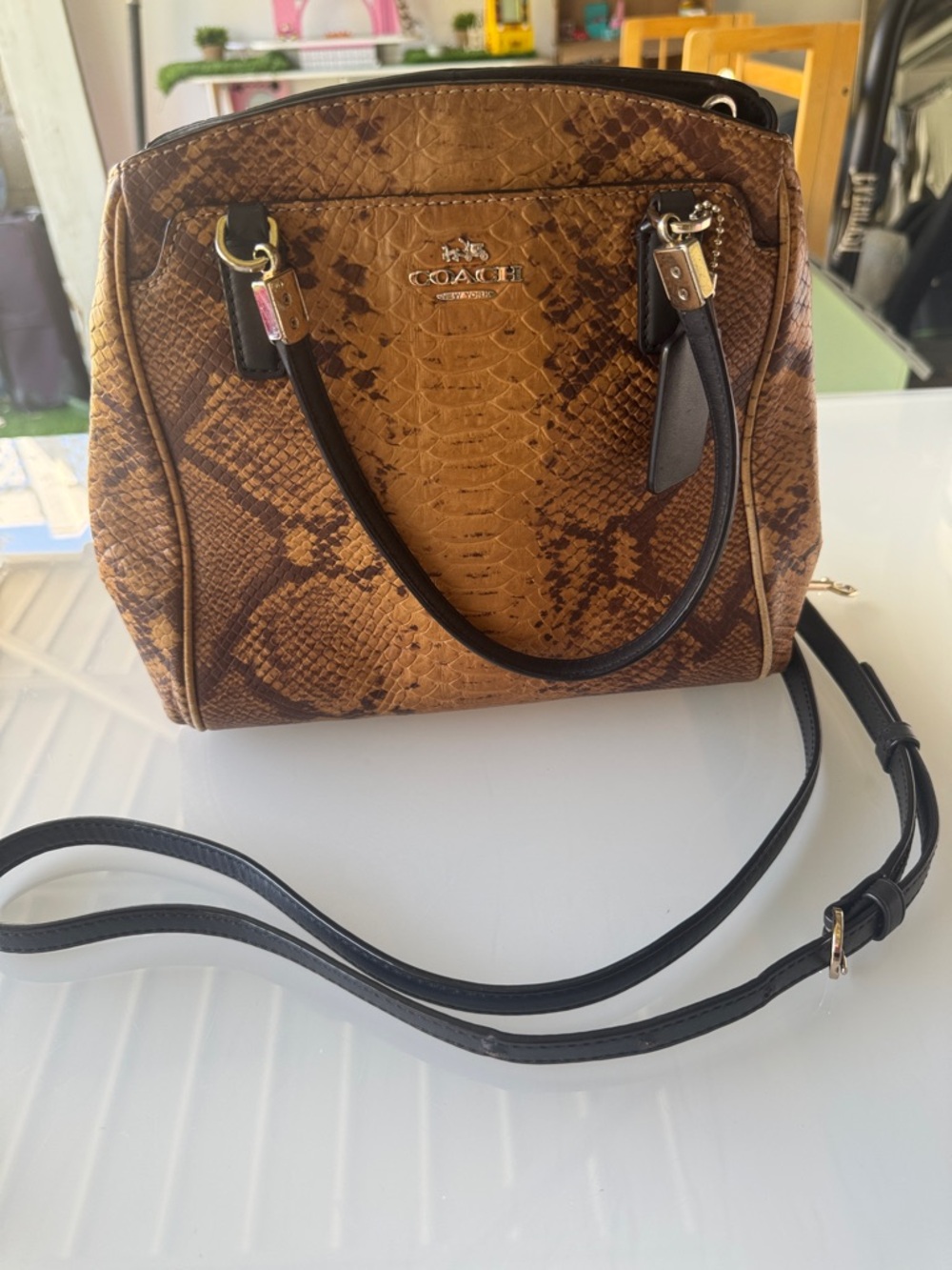 COACH Minetta Satchel crafted from brown snakeskin-embossed leather